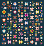 A quilt with a geometric pattern featuring various colored stars on a dark background.